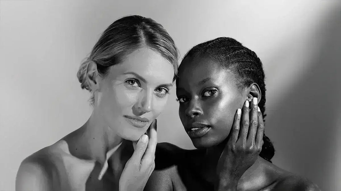 Black and white model hold their faces looking right at you