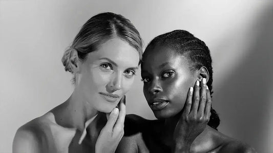 Black and white model hold their faces looking right at you