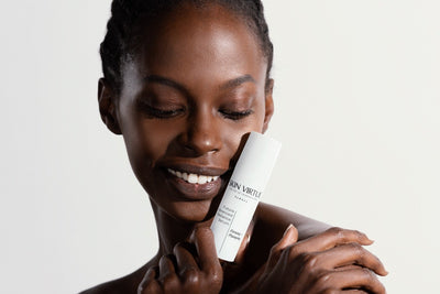 35 Year old Skin Virtue Model touching her face with a blurred background