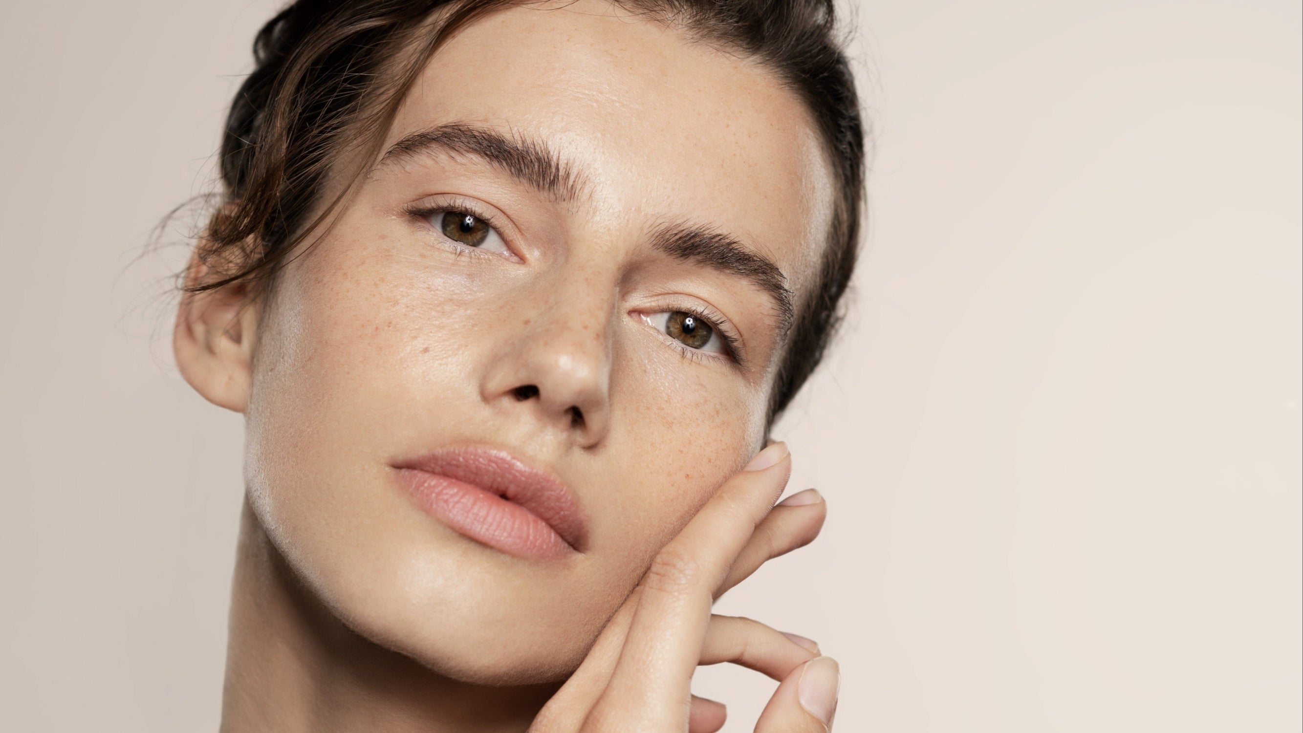 Model with hands on face using MOISTURISER