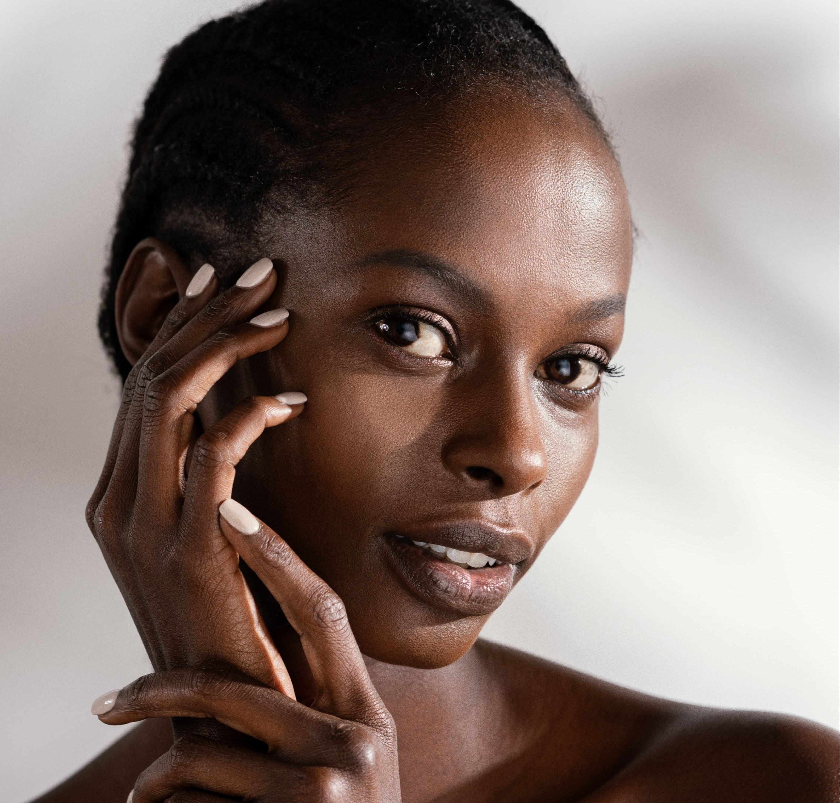 Black female model holding her face