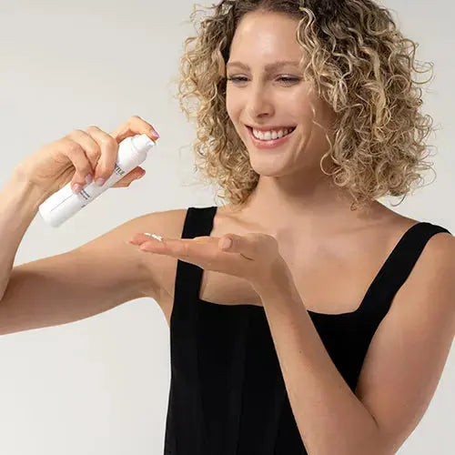 Model 25 years old holding Pure Nourish Moisturising Cream