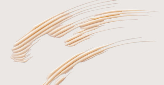Future Advanced Brightening formulation smeared across a flat bieg background 