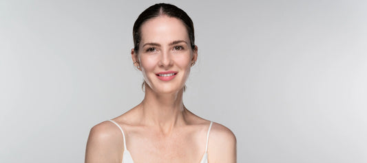 Image of Nina Williams smiling at the camera with a grey back drop