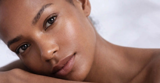 Skin Virtue model laying with her face on our arms smiling