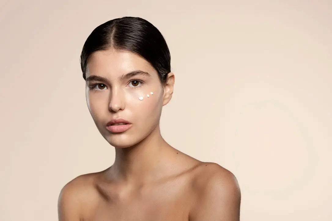 Skin Virtue Model with 3 dots of cream on her face looking at the camera