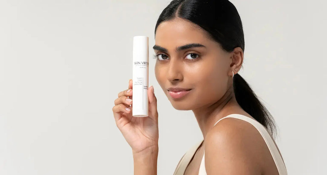 Model holding Skin Virtue Super Clear Purifying Crème Gel, a lightweight clarifying moisturiser that helps balance visible oiliness while maintaining hydration for oily and combination skin.