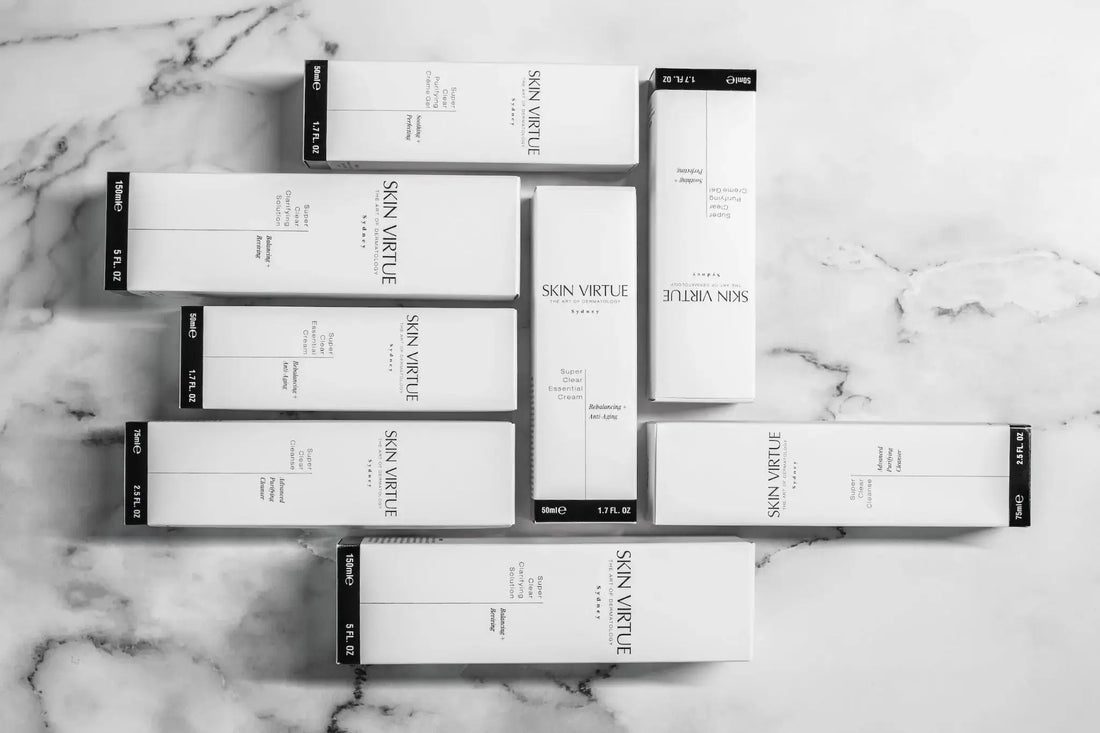 Skin Virtue Super Clear product boxes arranged on marble, representing a professional sensitive-first skincare pathway for clinics.