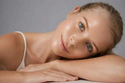 young model laying flat on her arms looking into the camera