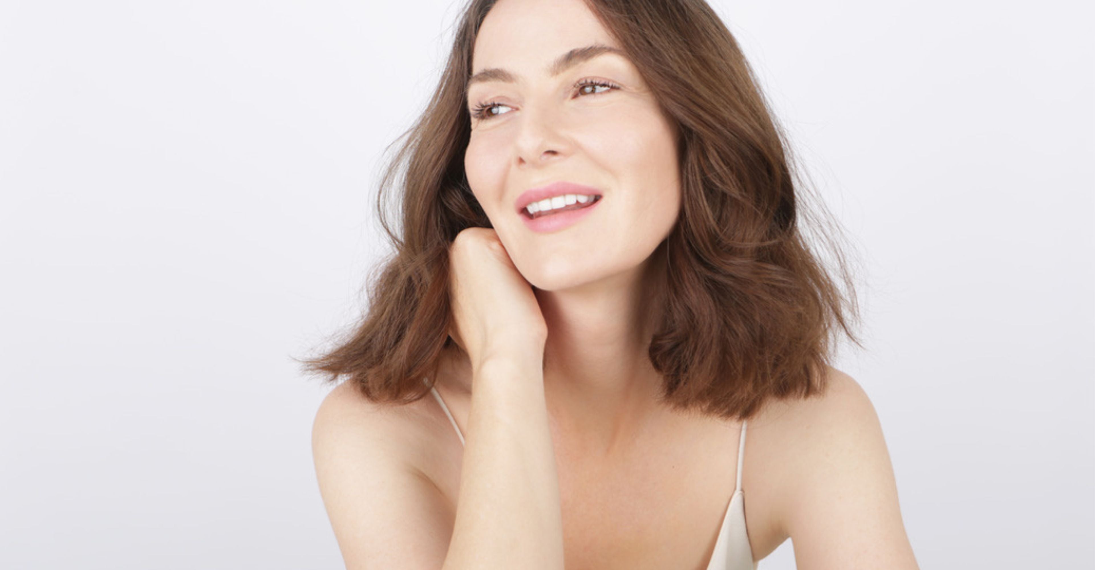 Nina Williams - Founder of Skin Virtue  with shoulder-length brown hair smiling against a light background