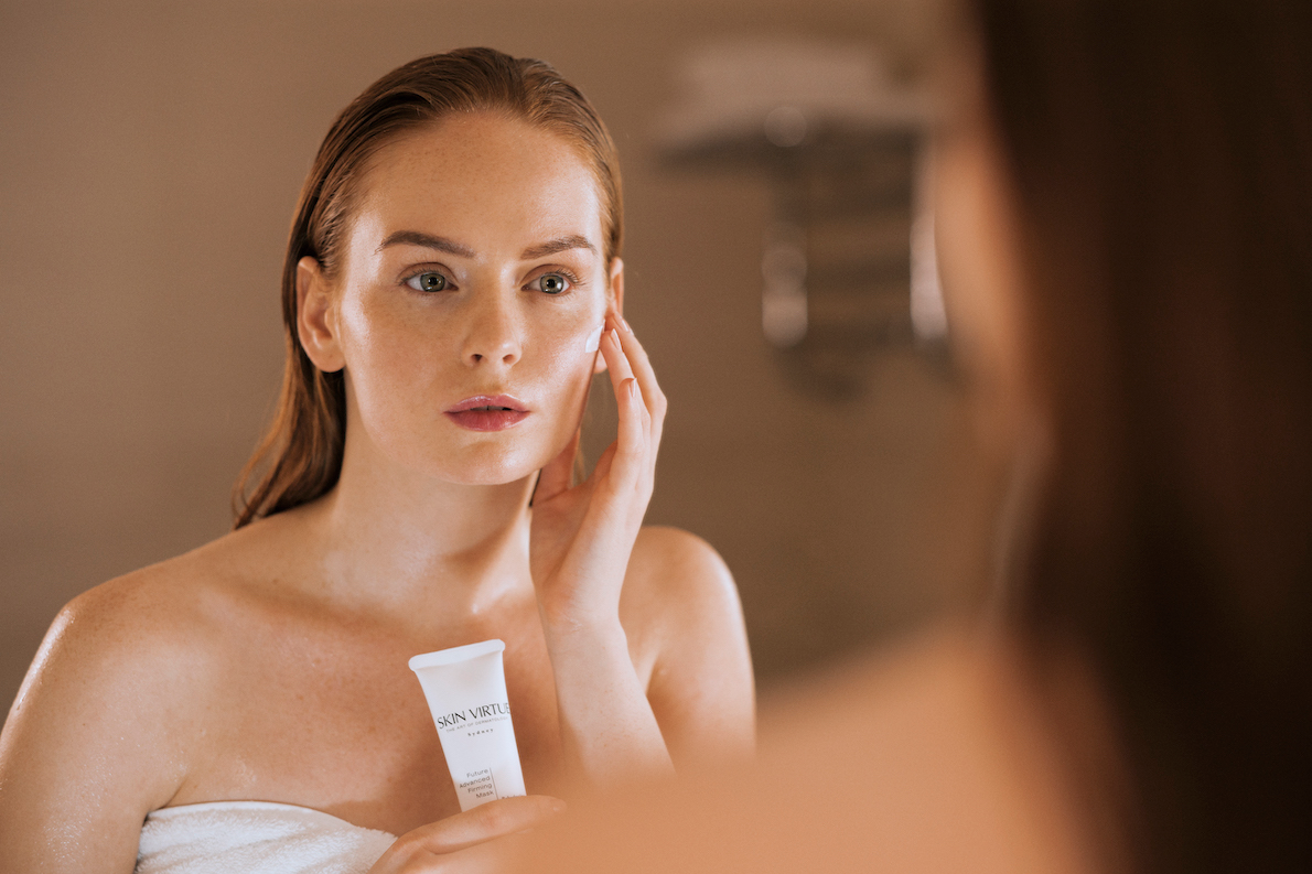 Future Advanced Firming Mask with Model in front of mirror | Skin Virtue